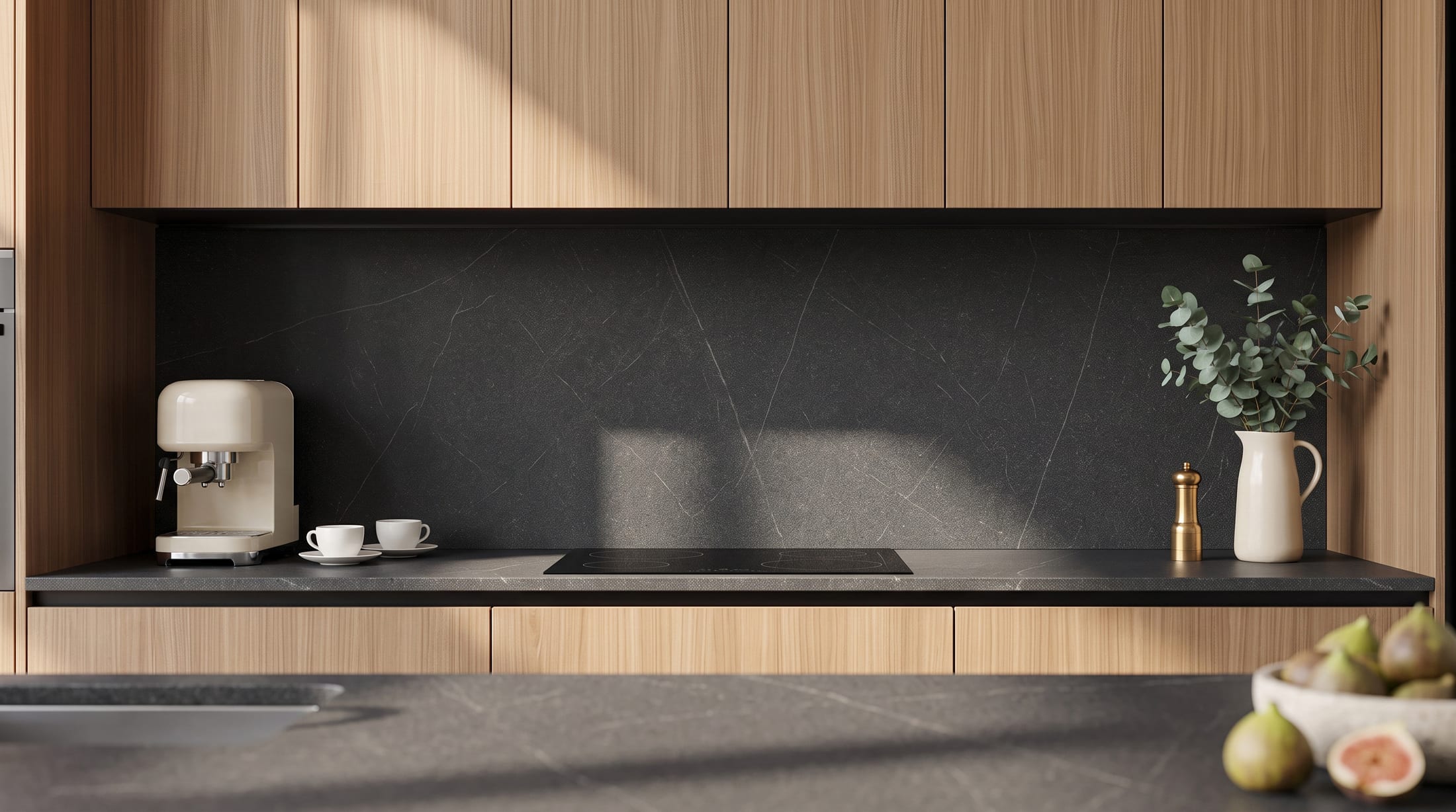 Gacaferi 1957 Stria custom kitchen — black splashback and worktop beneath pale oak wall units